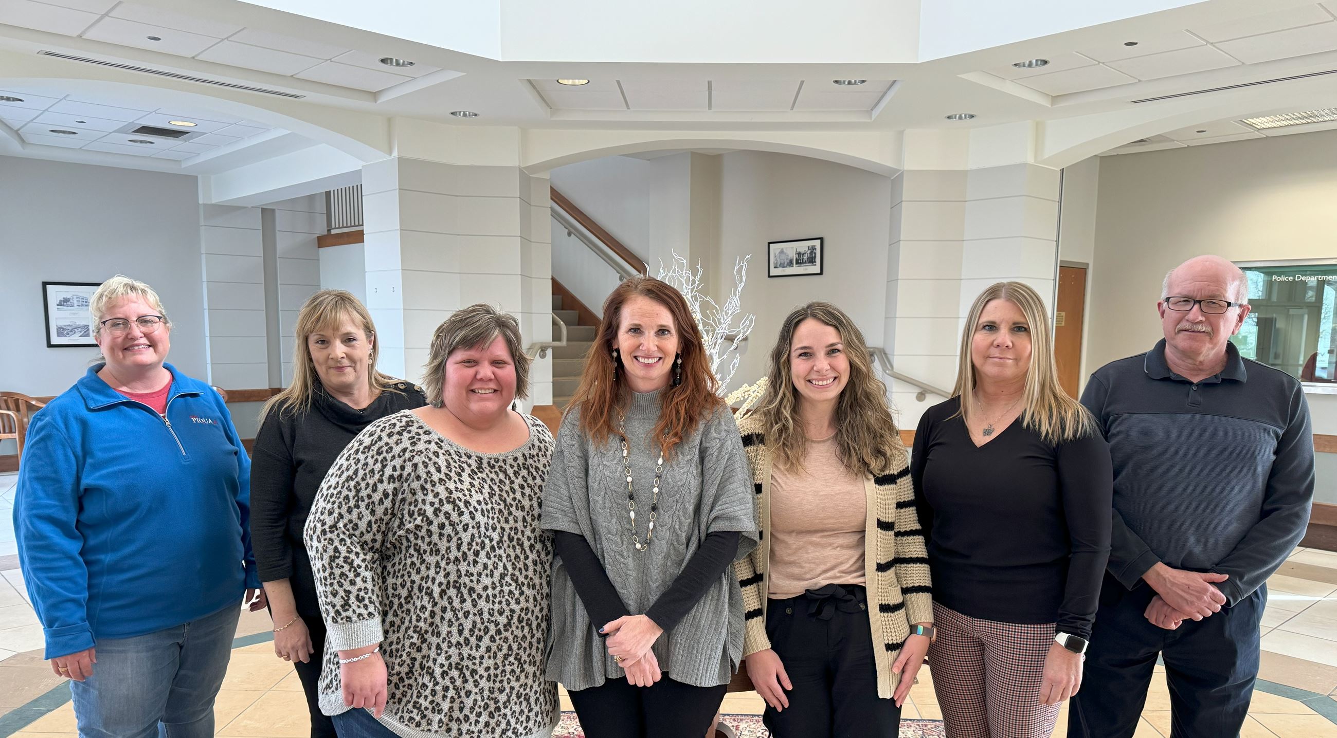 Group of people who work in the Finance Department posed in municipal government office 